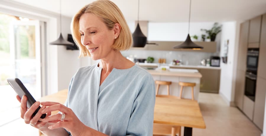 Resident using a smartphone in a room filled with sunlight